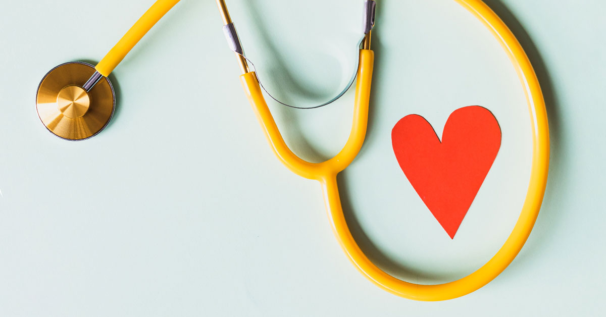 Photo of a stethoscope next to a paper heart