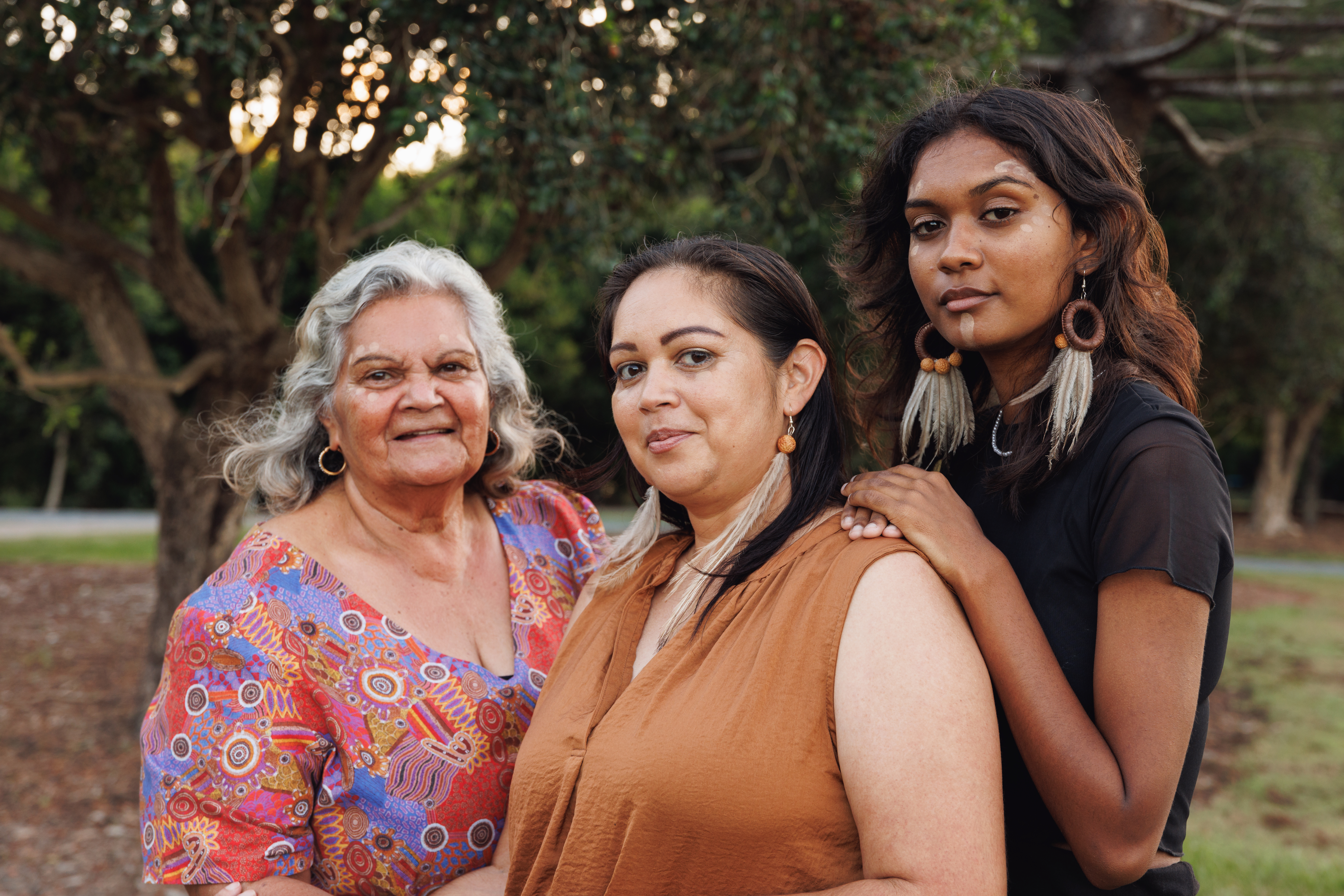 Three Generations Of Aboriginal Australian Women Doing Traditional Ochre Face Painting Three Generations Of Aboriginal Australian Women